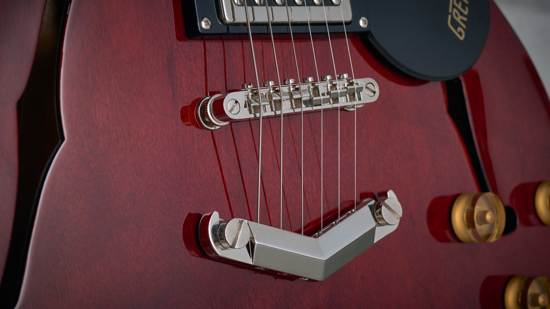 Close up of the bridge and tailpiece on a Gretsch electric guitar