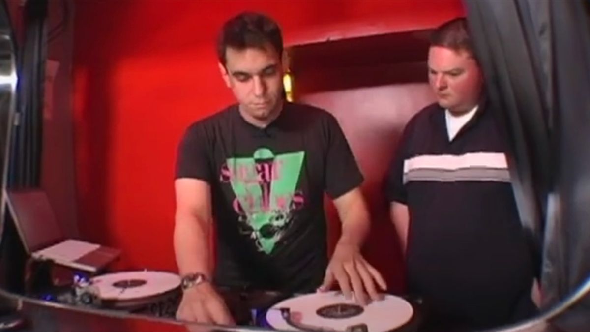 DJ AM sets up equipment.