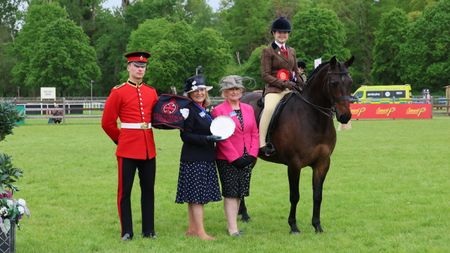 Isobel Radford Jones and Morning Sunflower stand for a photo with judges at the 2026 Royal Windsor Horse Show