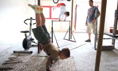 Brothers Giuliano (right) and Claudiu Stroe (left) can be seen in their gym doing vertical push-ups as part of their intense training regimen. 