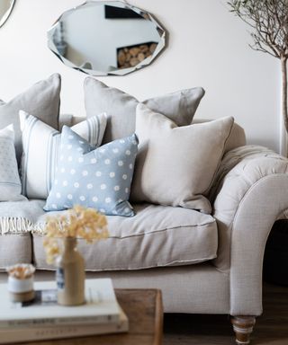 beige sofa with coastal blue linen pillows