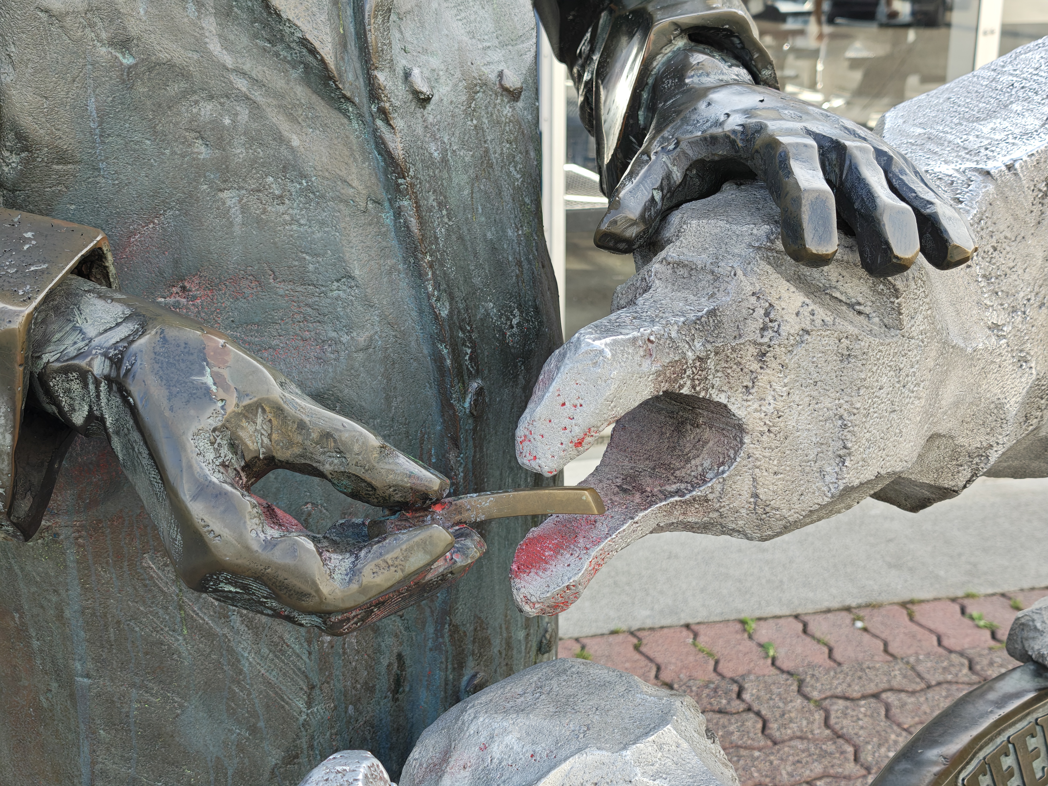 A statue of a man feeding a seagul