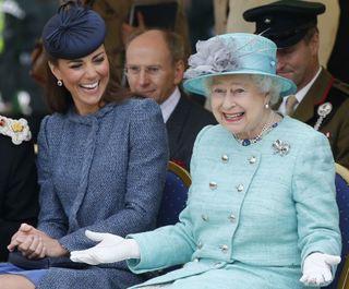 Catherine, Duchess of Cambridge and Queen Elizabeth II watch part of a children's sports event