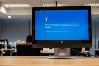 A Windows 10 blue screen error message displayed on a monitor