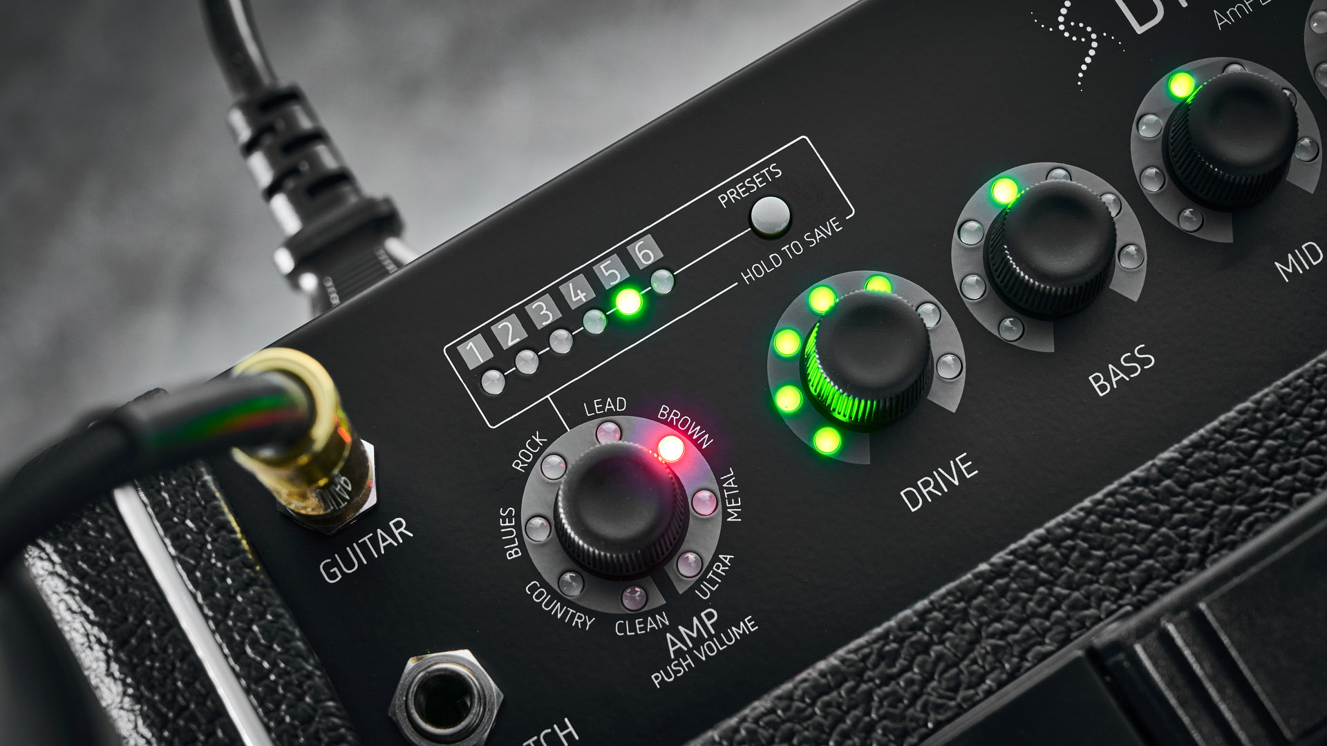 Harley Benton DNAFX AmP20: the compact 1/8&quot; modelling combo is finished in black and photographed in close-up and against a slate floor