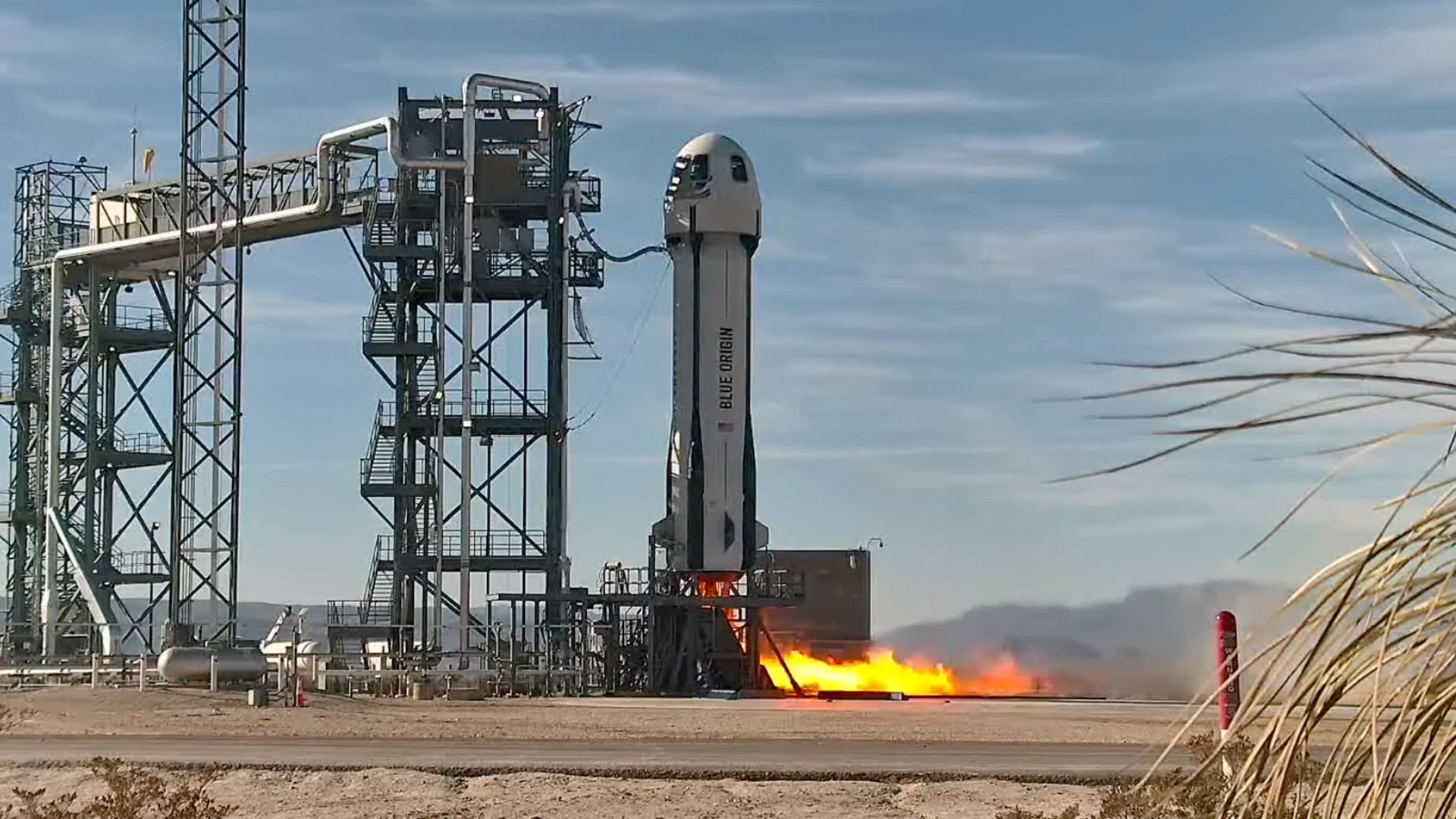 Squat white rocket with dome-shaped top lifted from the desert floor