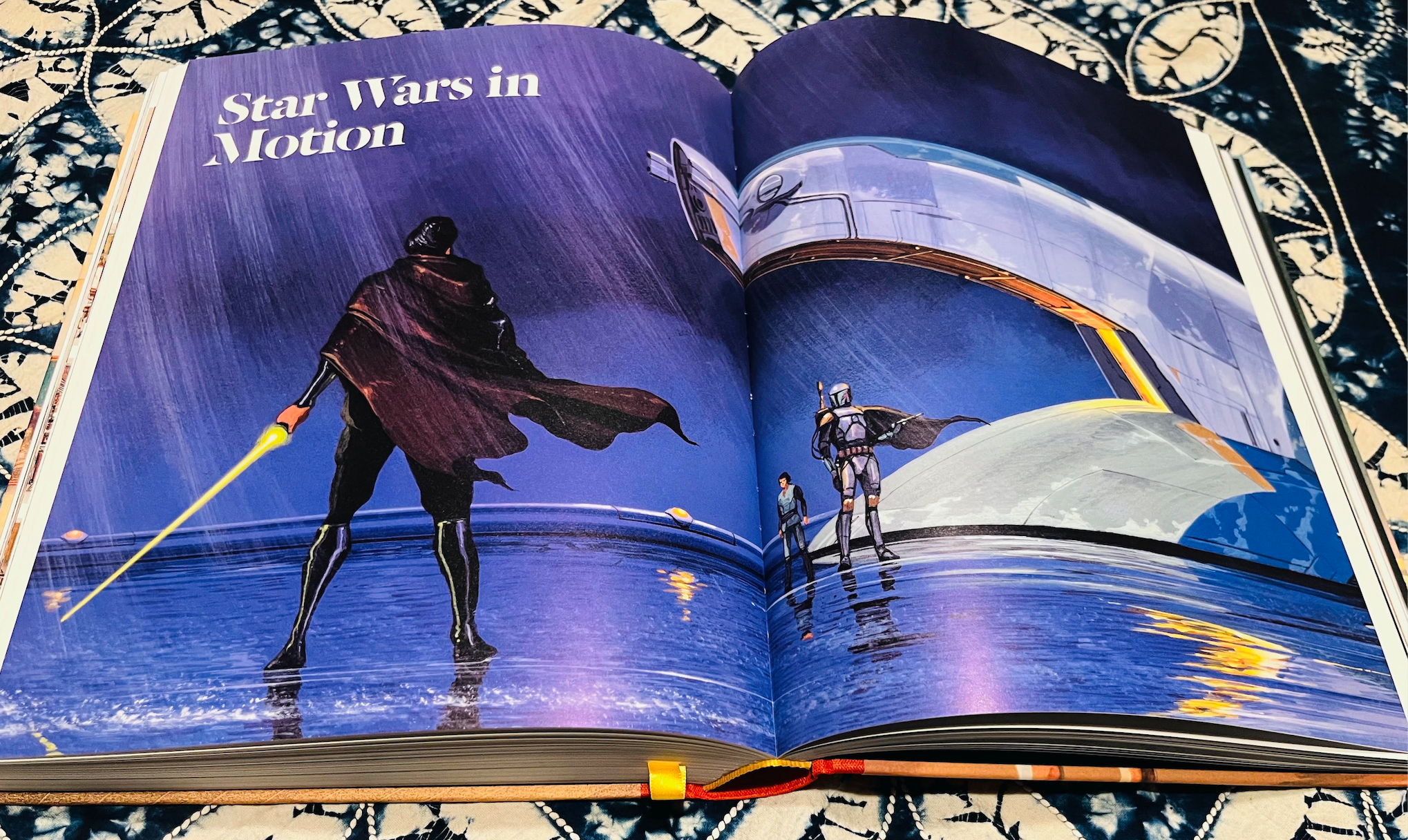 an open book with pages depicting sci-fi art