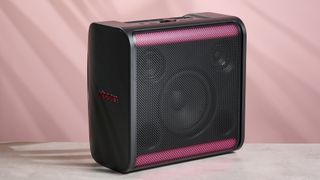LG xboom Stage 301 against a pink background