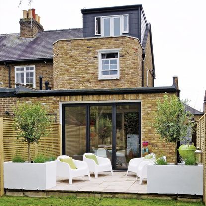 sloping roof house with exposed brick walls and white windows