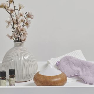 Aroma Home harmony diffuser with dried flowers and a sleep mask next to it