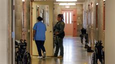 A female prison inmate enters her room at the Central California Women's Facility in Chowchilla, California.