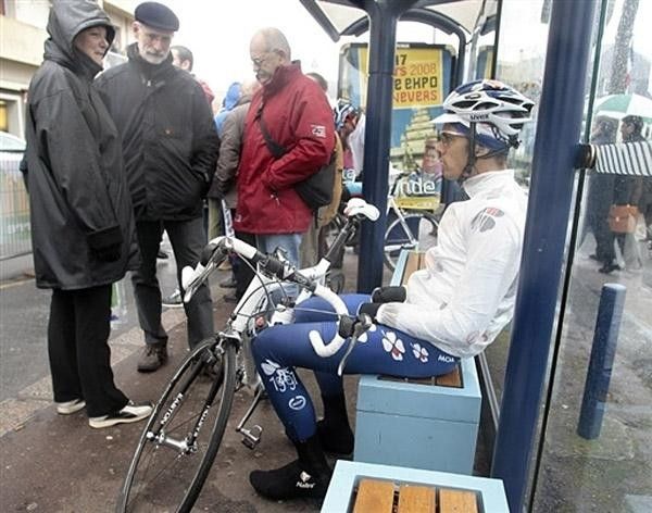 Remy Di Gregorio (FdJ) stares distractedly into space as fans ogle his bike.
