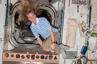 NASA astronaut Karen Nyberg, Expedition 37 flight engineer, poses for a photo while floating freely in the Unity node of the International Space Station on Sept. 16, 2013.