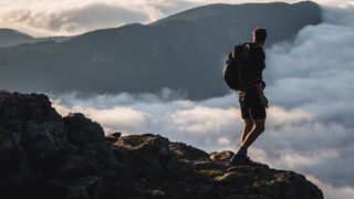 A hiker stands above the clouds on the Appalachian mountains