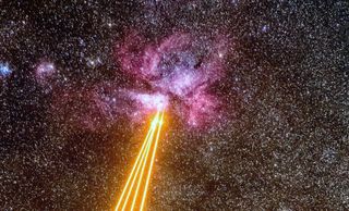 Lasers fly through space toward the glowing Carina Nebula