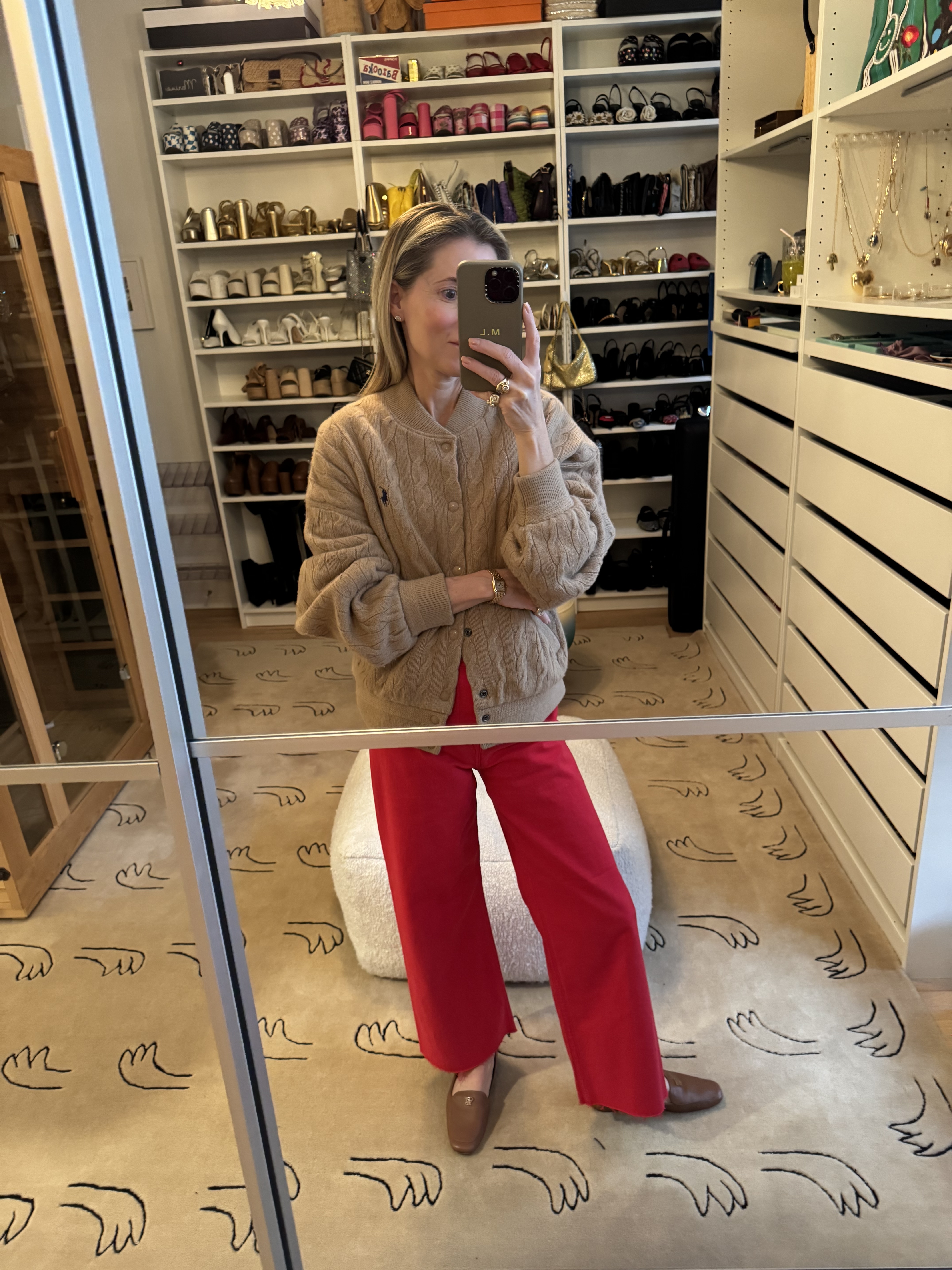 Marina Larroud&amp;eacute; wearing a knit bomber jacket with red jeans and brown loafers