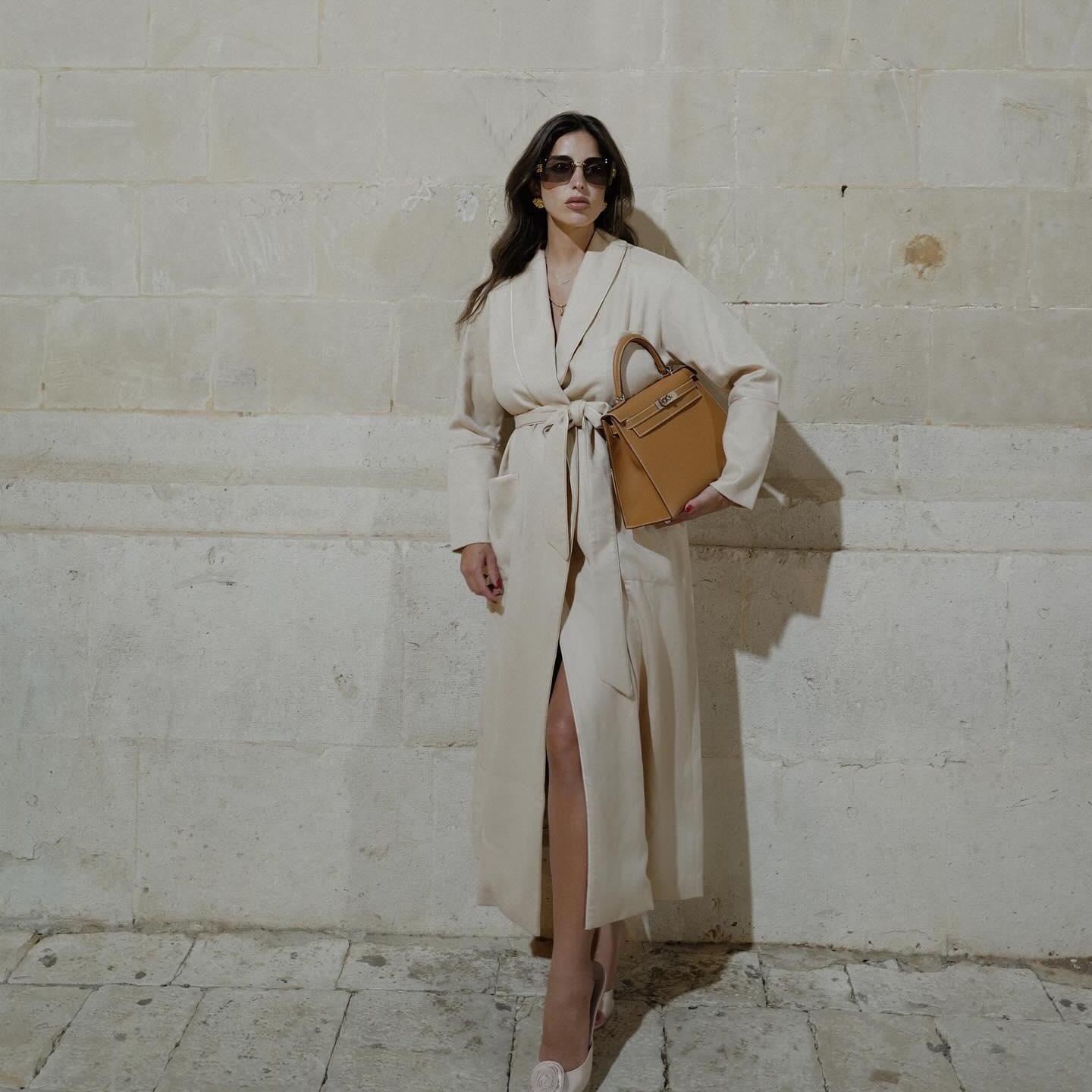 Bettina Looney wearing a long tan coat.