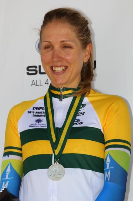 A victorious Shara Gillow stands on the podium having won her third Australian ITT title