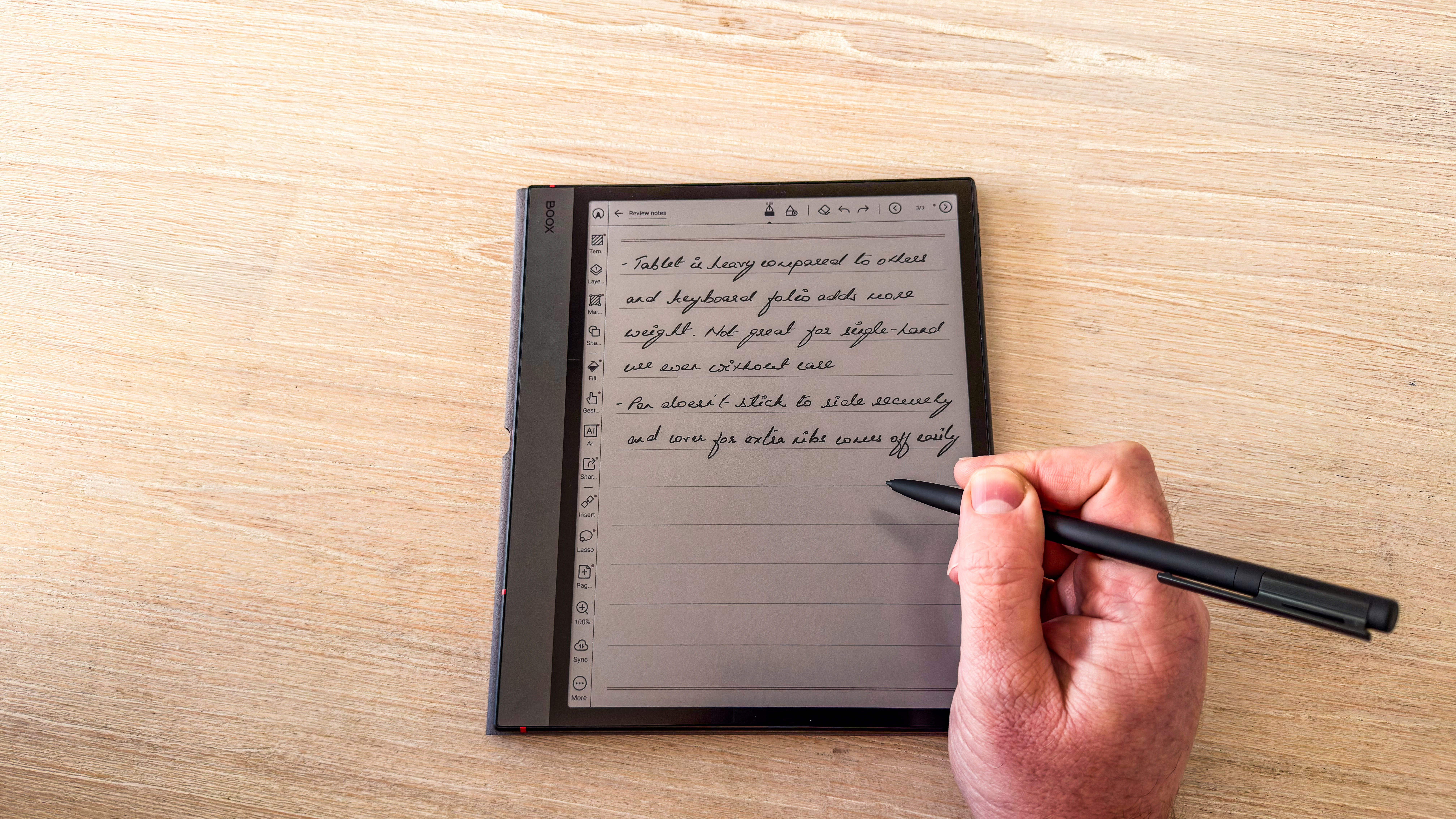 A person writing with the Boox Pen 3 on the Boox Note Air5 C