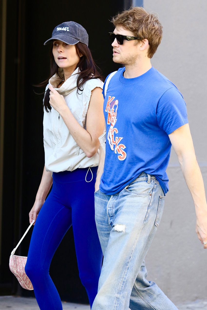 Mary Beth Barone wearing cobalt leggings, walking with Joe Alwyn in NYC