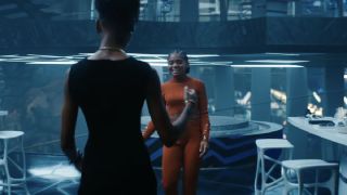 Ironheart (orange) and Shuri talking in Black Panther: Wakanda Forever.