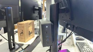 An MSI mini PC mounted to the back of a monitor at Computex