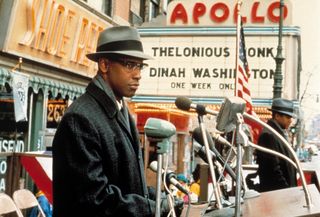 denzel washington walking through 60s era harlemn in the movie malcolm x