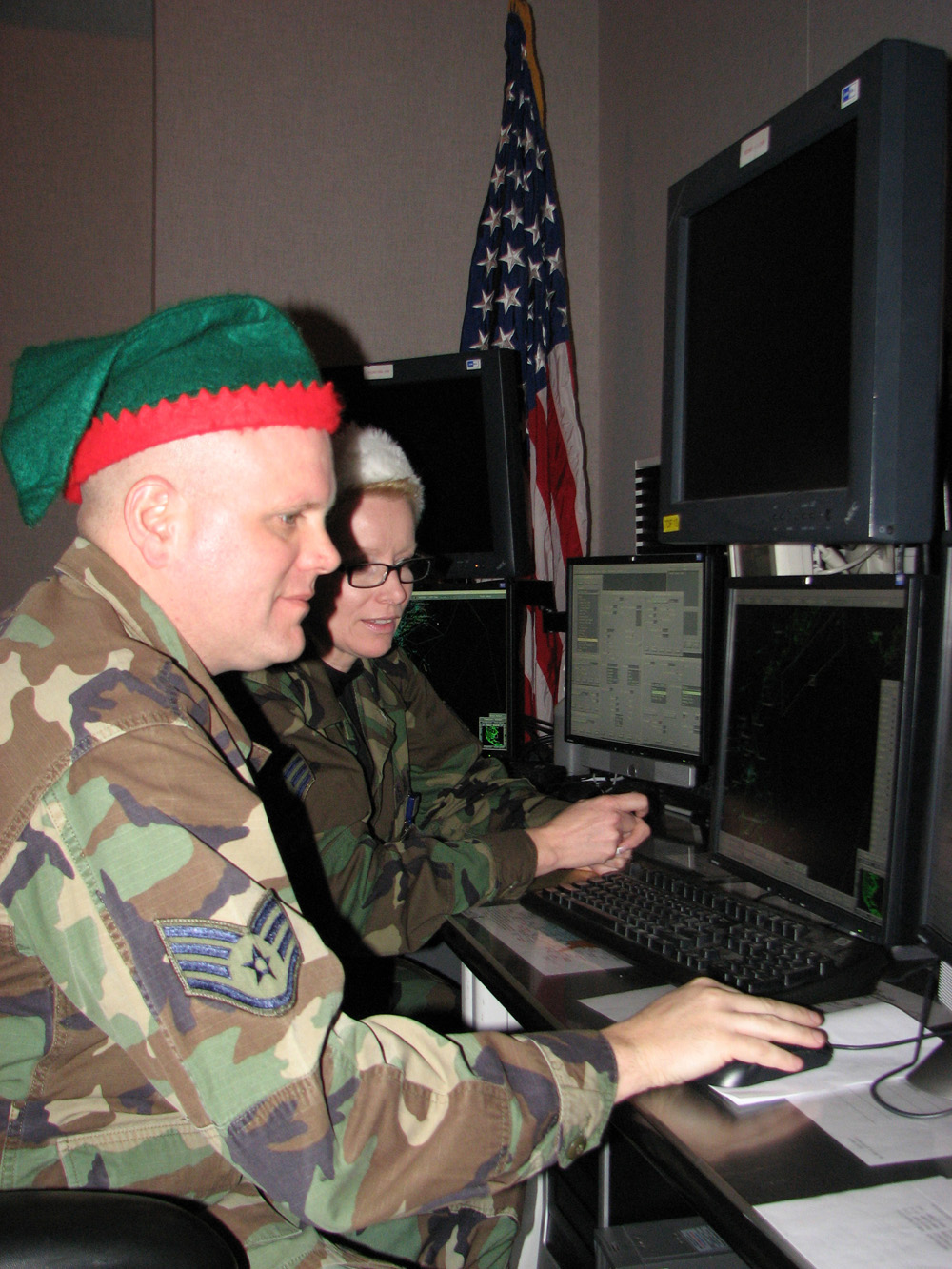 Two members of NORAD&#039;s Northeast Air Defense Sector get ready to track Santa Claus using radar equipment in December 2008 . 