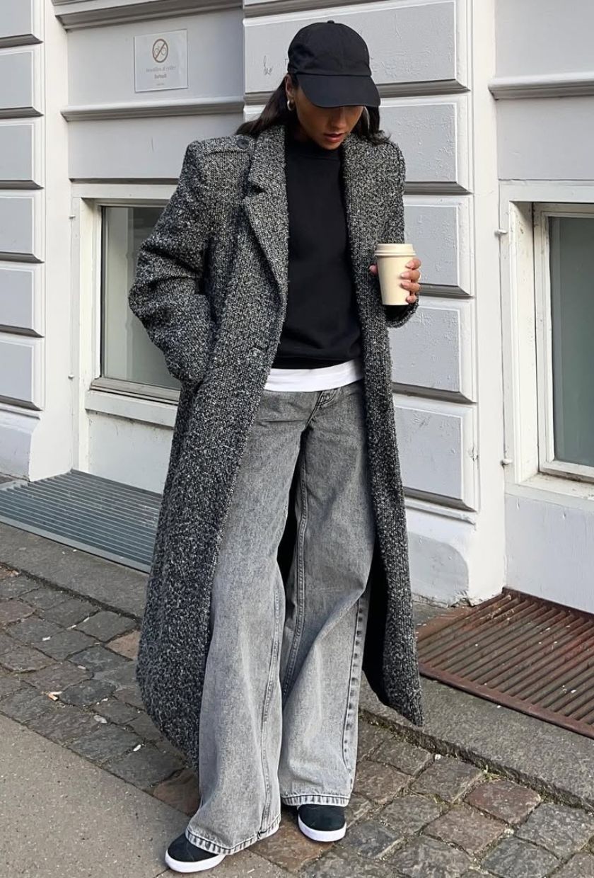 @ingridedvinsen wears a grey wool maxi coat, black jumper, grey jeans, black and white trainers and a black baseball cap
