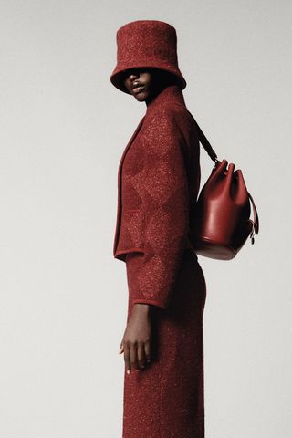 model wearing red hat for loro piana's spring 2025 collection