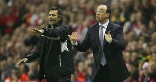 Jose Mourinho the manager of Chelsea and Rafael Benitez the manager of Liverpool shout instructions to their players during the Champions League semi final second leg match between Liverpool and Chelsea at Anfield on May 3, 2005 in Liverpool, England.