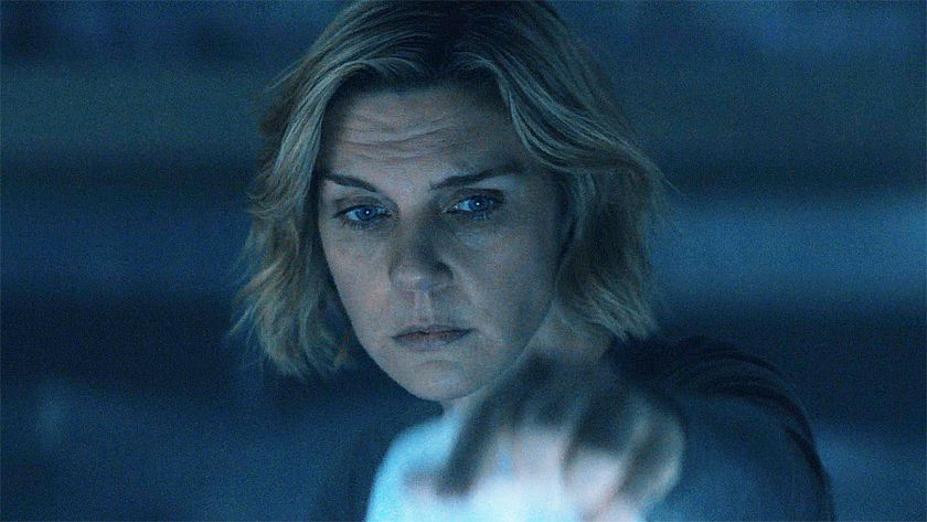 Carol lifting up a plastic sheet in a dark room in Pluribus episode 5