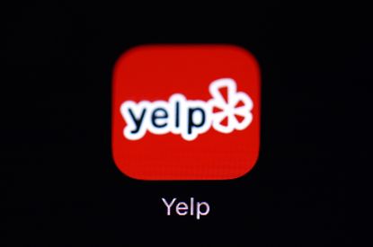 This March 19, 2018, file photo shows the Yelp app on an iPad in Baltimore. Yelp reports financial results Thursday, Aug. 8, 2019.