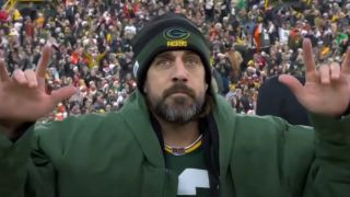 Aaron Rodgers throwing up devil horns after touchdown record