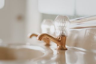 copper bathroom taps with glass top detail