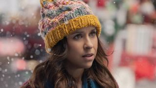 Kathy Barrett in knitted hat while it snows in Netflix's Hot Santa