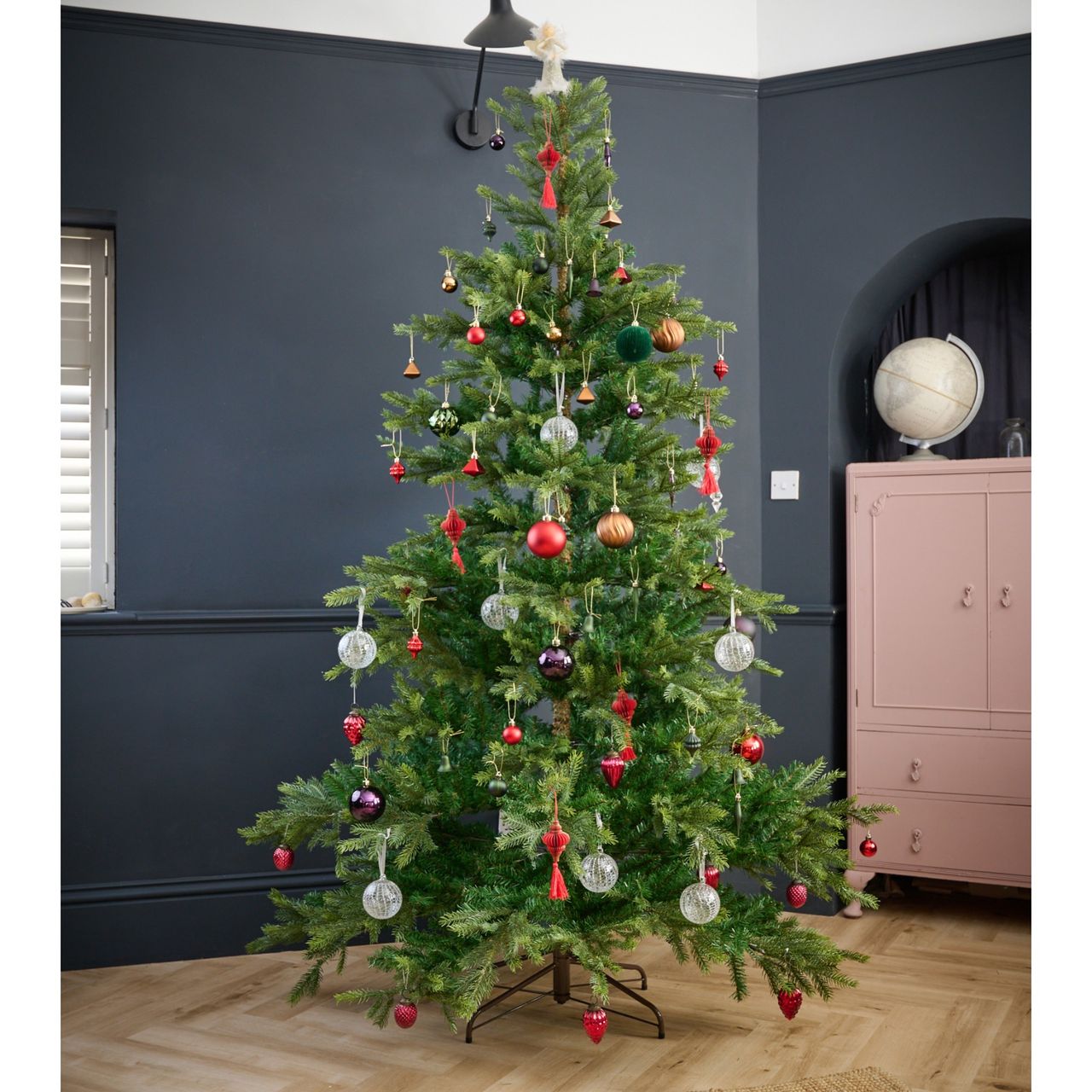 The White Company's 7.5ft Grand Spruce Christmas Tree decorated with Christmas baubles in a black-painted living room
