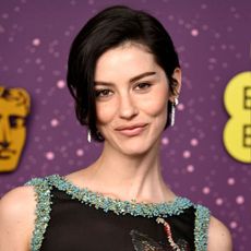 A photo of Gracie Abrams at the BAFTAs 2026 red carpet, featuring her bixie haircut