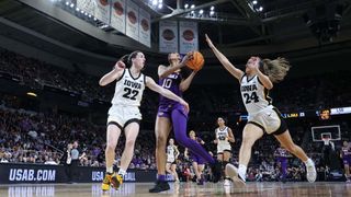 Angel Reese #10 of the LSU Tigers shoots the ball over Caitlin Clark #22 and Gabbie Marshall #24 of the Iowa Hawkeyesduring the first half in the Elite 8 round of the NCAA Women's Basketball Tournament at MVP Arena on April 01, 2024 