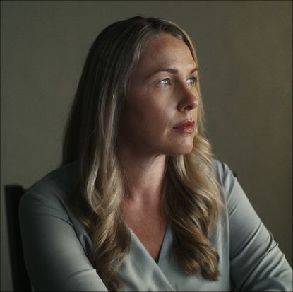 a blonde woman, denise huskins, looks off to the right