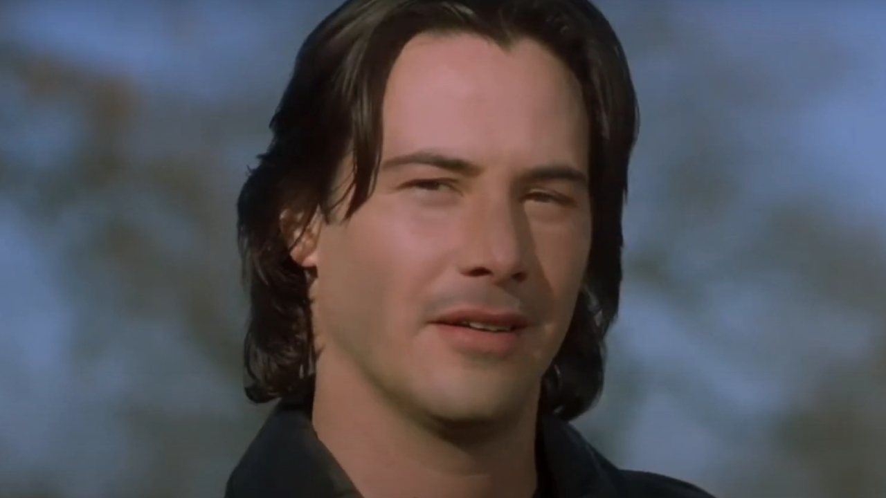 Keanu Reeves sporting a devilish grin in The Watcher