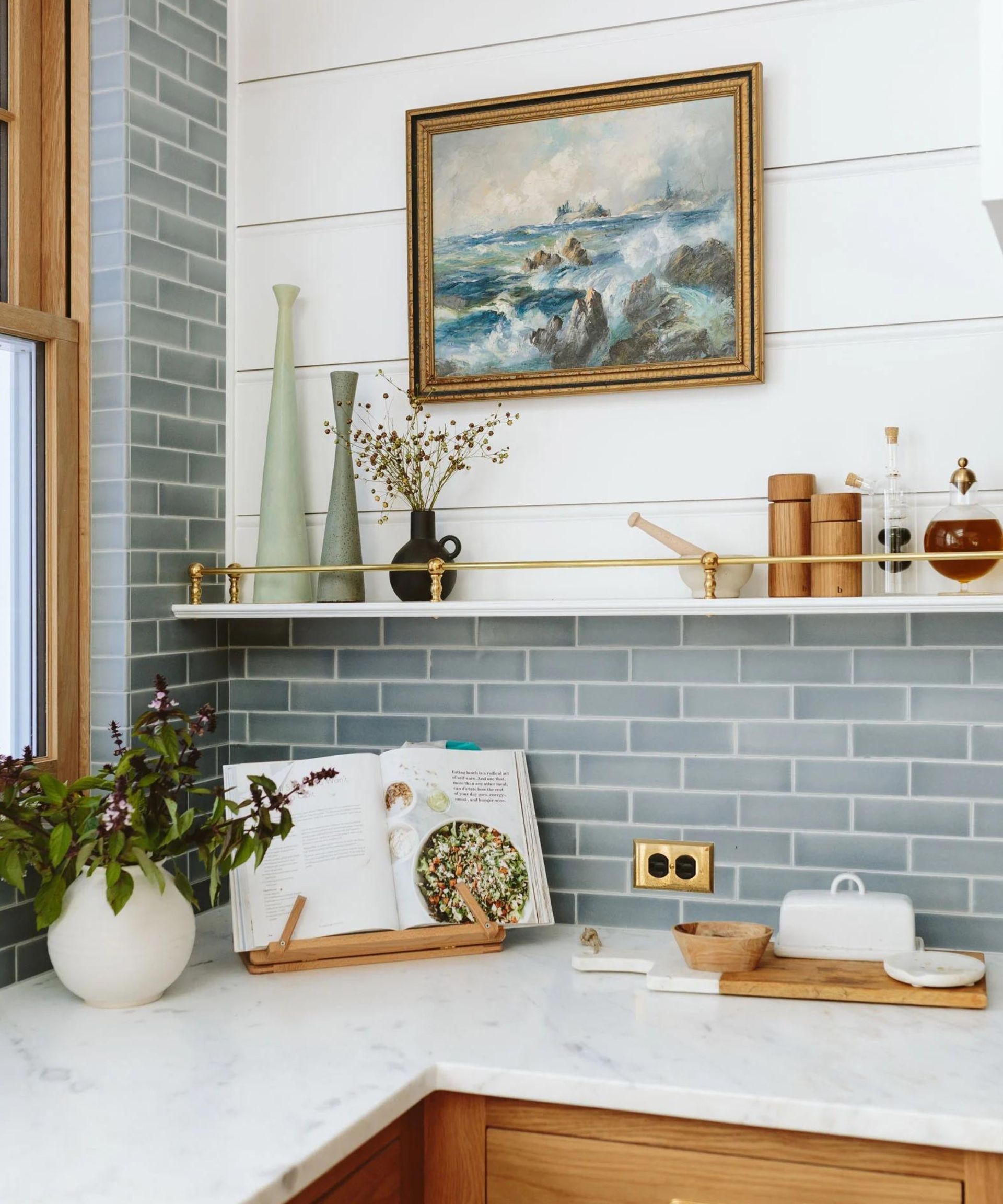 A kitchen with light blue backsplash and white countertops