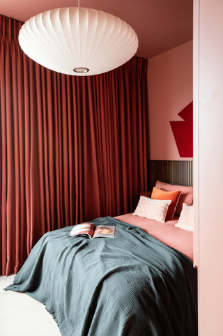 Red curtains in a pink bedroom