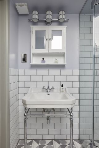 A bathroom with half tile and half paint
