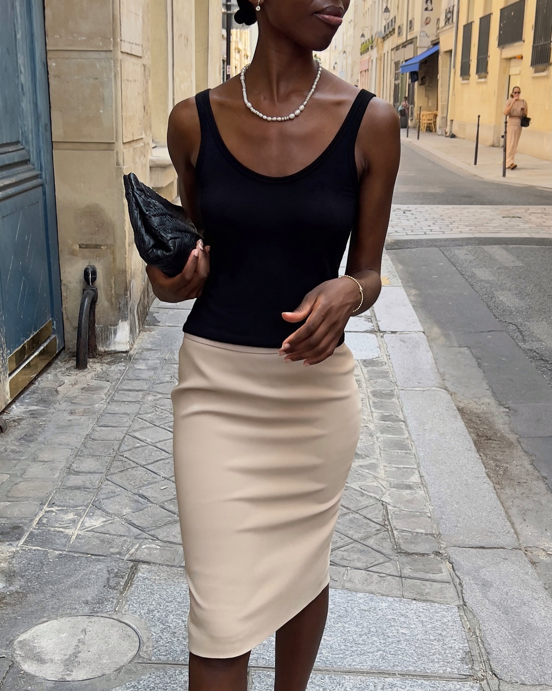 Woman showing how to wear a clutch this fall.