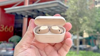 Listing image for best Apple AirPods alternatives showing Jabra Elite 10 listing image shot in charging case held in hand with lid open 