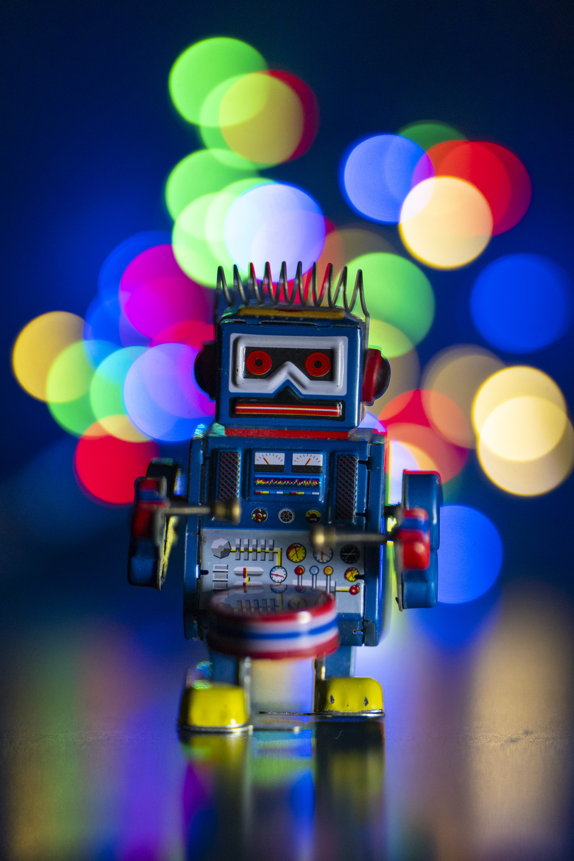 A test shot of a toy metal robot with string lights set up behind it to produce bokeh at different apertures