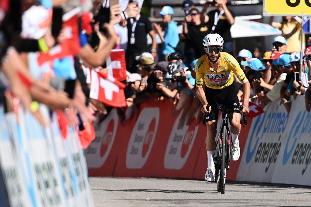 CARI SWITZERLAND JUNE 13 Adam Yates of The United Kingdom and UAE Team Emirates Yellow leader jersey sprint at finish line to win the stage during the 87th Tour de Suisse 2024 Stage 5 a 1486km stage from Ambri to Cari 1636m UCIWT on June 13 2024 in Cari Switzerland Photo by Tim de WaeleGetty Images
