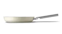 Smeg non-stick frying pan in cream finish on white background. Also available in black and red