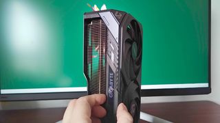 Gigabyte GeForce RTX 5070 Ti graphics card with hand moving sliding RGB cover